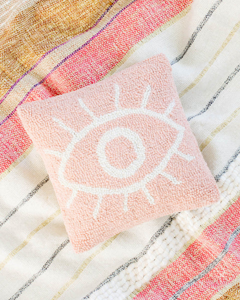 Pink handmade hook pillow with white eye design