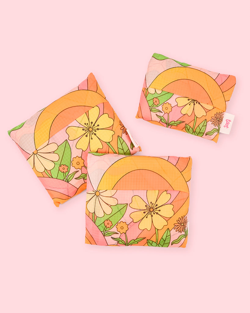 retro inspired groovy reusable market bag with vintage flower motif folding into travel size pouch