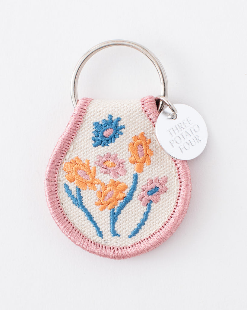 pastel patch keychain with pink yellow and blue embroidered wildflowers