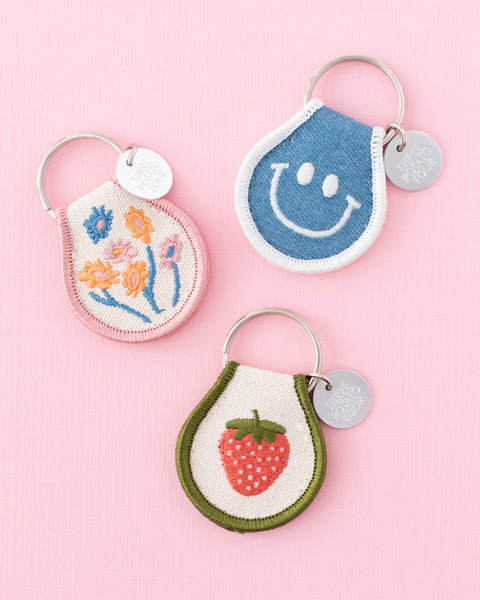 strawberry patch keychain with green and pink embroidered strawberry