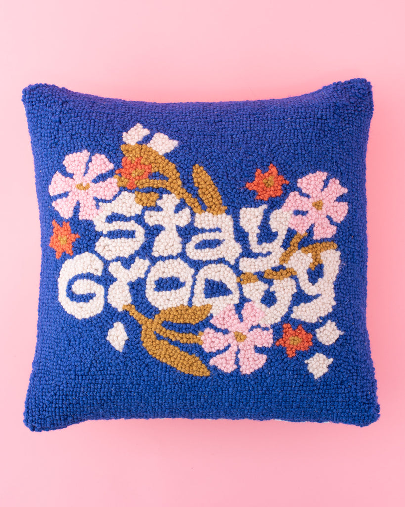 handmade blue hook pillow with floral design and groovy white text 'stay groovy'